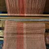 Photograph of an in-process weaving still attached to an indigenous Taiwanese backstrap loom